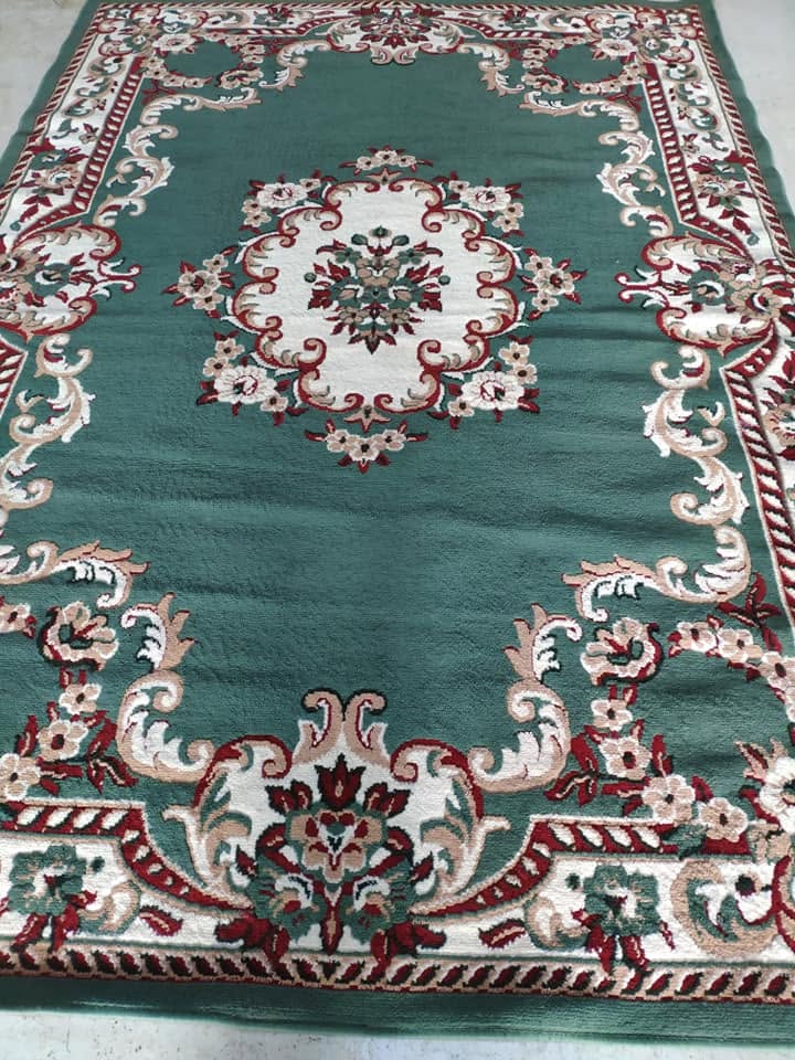 Rug cleaning technician assessing a wool rug in Adelaide