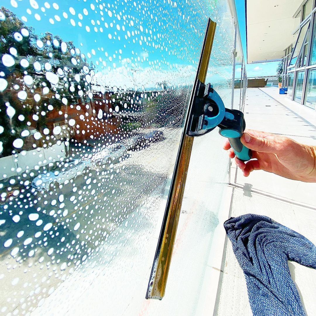 Window cleaner working on a house window in Adelaide